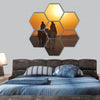 Camels riding towards the sun in the desert hexagonal canvas wall art