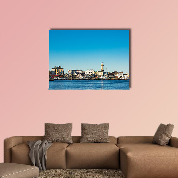 Buildings, lighthouse and blue sky in Warnemuende, Germany wall art