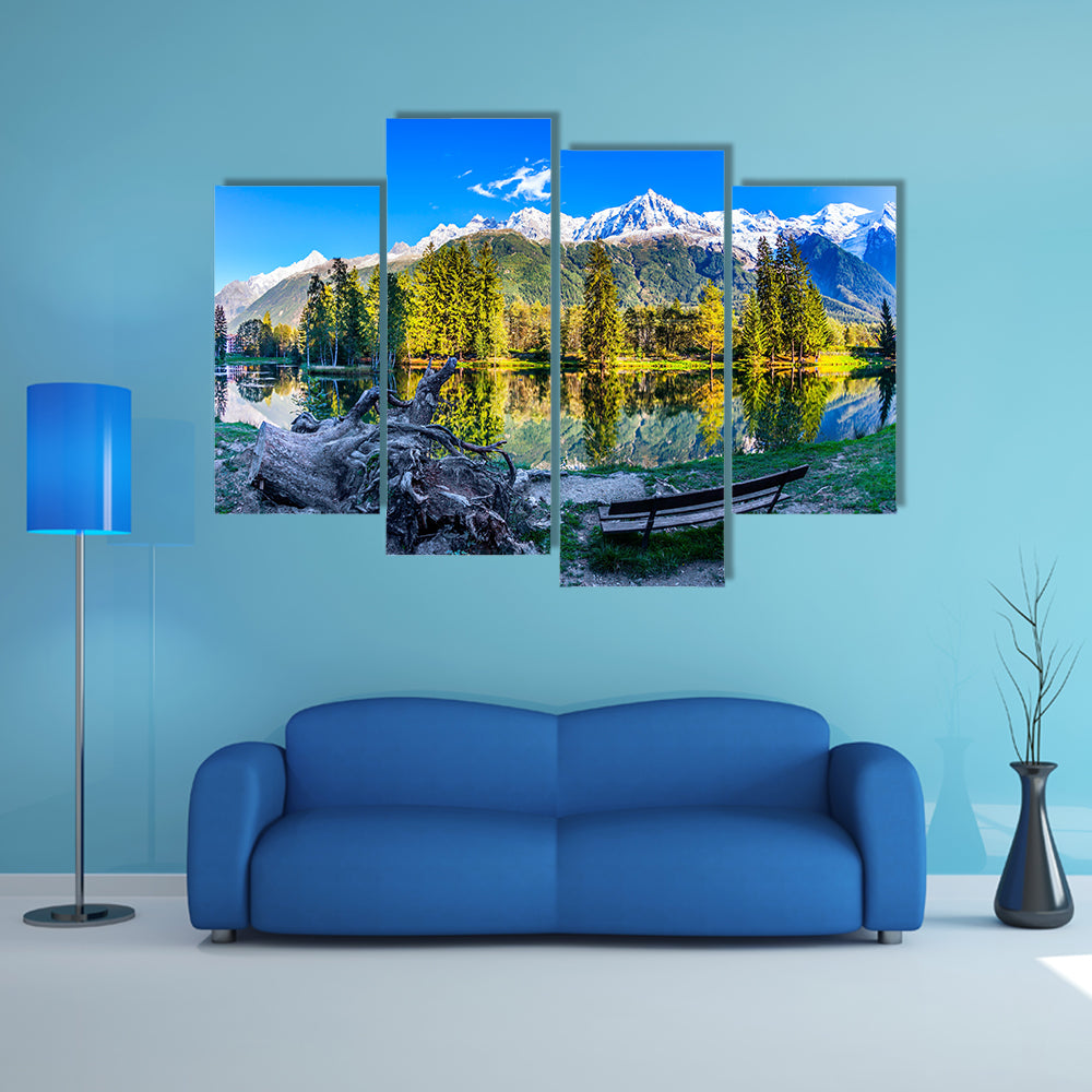 The bench in the city park in the Chamonix City Park is illuminated by sunset multi panel canvas wall art