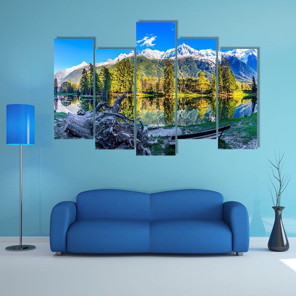 The bench in the city park in the Chamonix City Park is illuminated by sunset multi panel canvas wall art