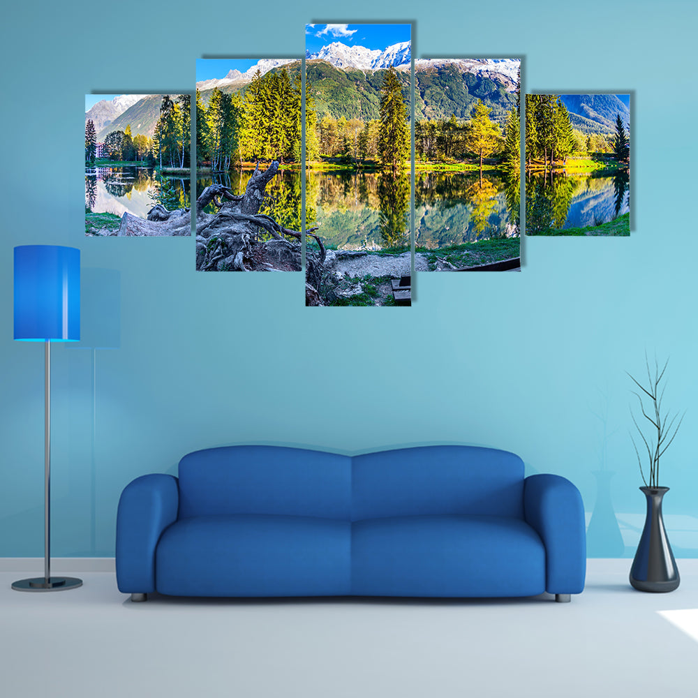 The bench in the city park in the Chamonix City Park is illuminated by sunset multi panel canvas wall art