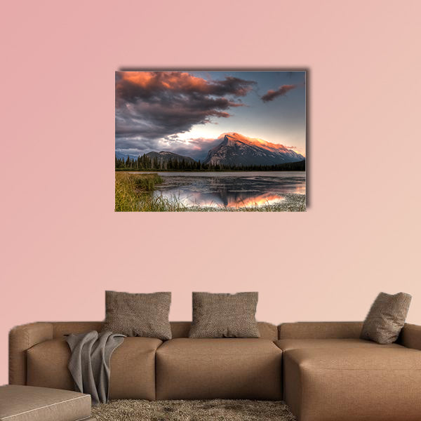 Pink clouds moving over the top of a mountain during canvas wall art