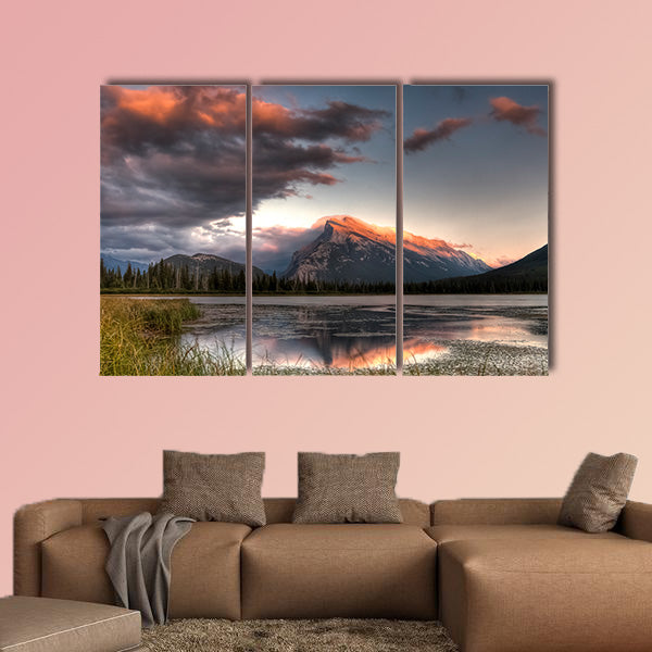 Pink clouds moving over the top of a mountain during canvas wall art