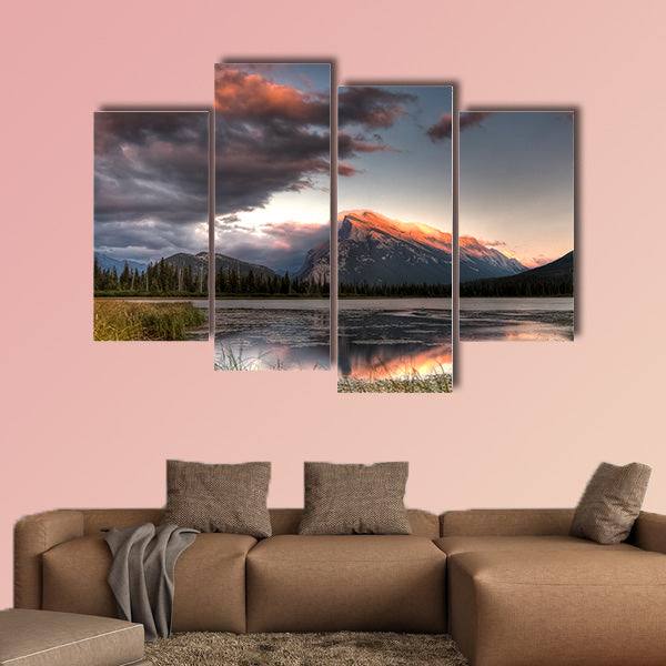 Pink clouds moving over the top of a mountain during canvas wall art