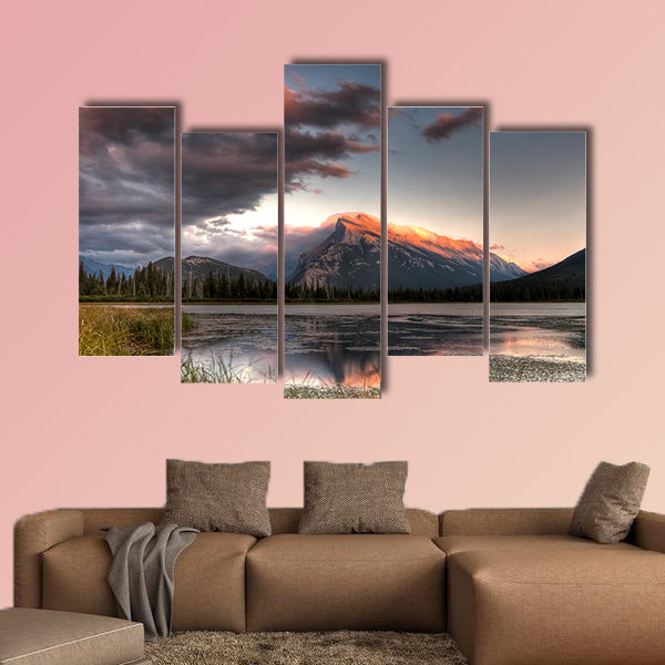 Pink clouds moving over the top of a mountain during canvas wall art