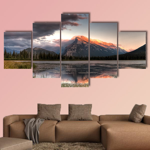 Pink clouds moving over the top of a mountain during canvas wall art