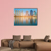 Blue twilight office building with water reflection multi panel canvas wall art