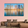 Blue twilight office building with water reflection multi panel canvas wall art