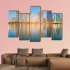 Blue twilight office building with water reflection multi panel canvas wall art