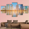 Blue twilight office building with water reflection multi panel canvas wall art