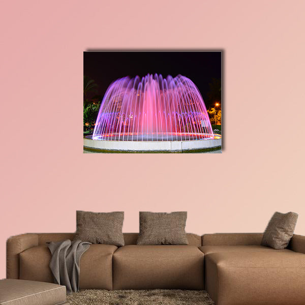 A LED lighted fountain near Mediterranean Sea shore multi panel canvas wall art