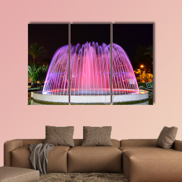 A LED lighted fountain near Mediterranean Sea shore multi panel canvas wall art