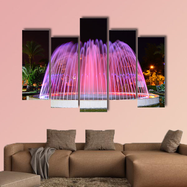 A LED lighted fountain near Mediterranean Sea shore multi panel canvas wall art