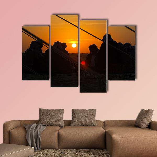 Arab men around a fire place in the desert at sunrise multi panel canvas wall art