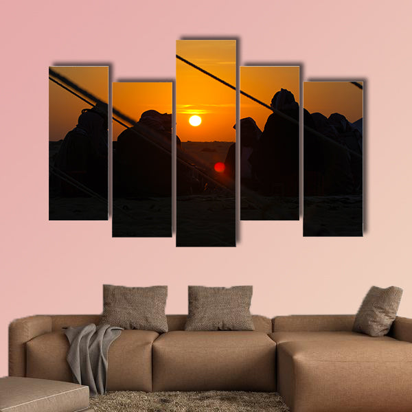 Arab men around a fire place in the desert at sunrise multi panel canvas wall art