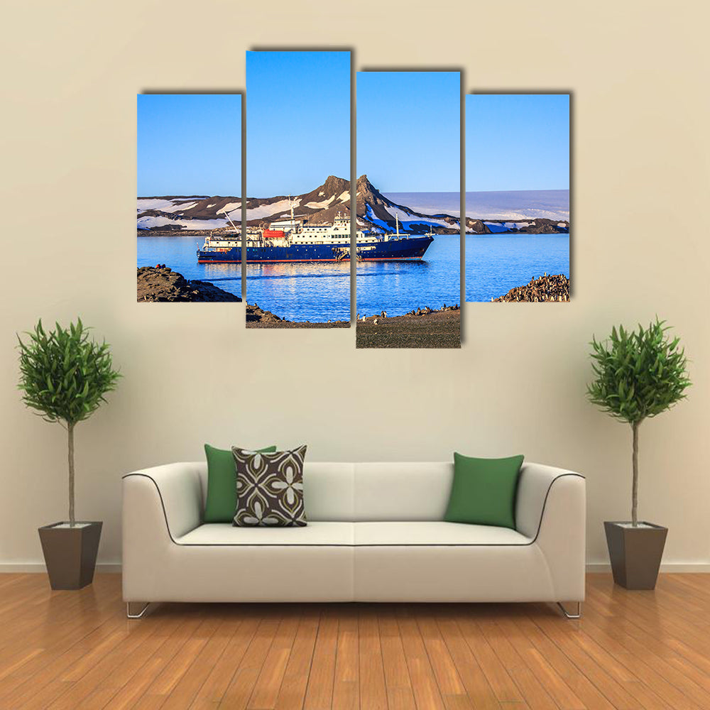 Blue antarctic cruise ship in the lagoon and penguins colony on the island Multi panel canvas wall art