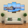 Blue antarctic cruise ship in the lagoon and penguins colony on the island Multi panel canvas wall art