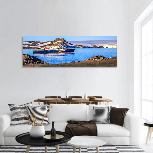 Blue antarctic cruise ship on the shore of Barrientos island, Panoramic canvas Wall Art
