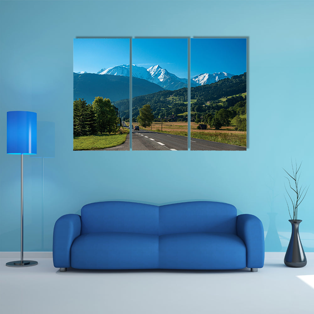 Road between fields, green forest and alpine landscape in a sunny day, multi panel canvas wall art