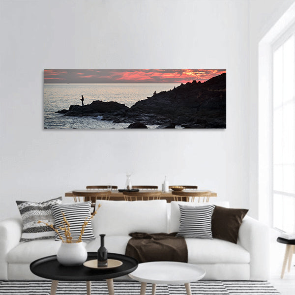 Fisher at cliff coast during sunset Panoramic canvas Wall Art