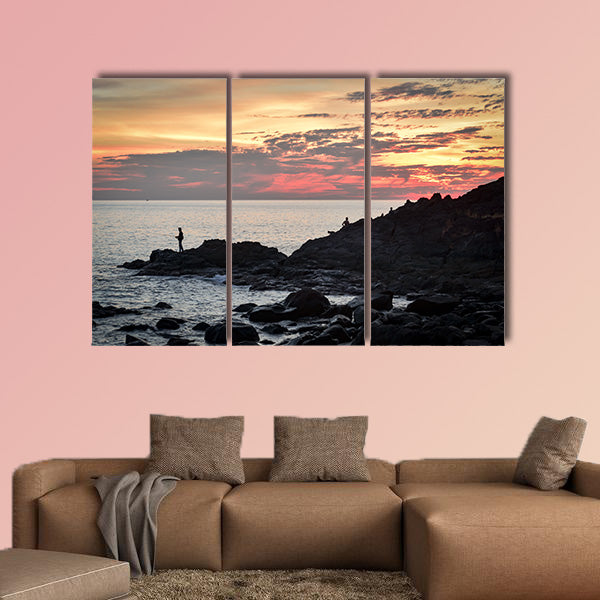 Fisher at cliff coast during sunset Multi panel canvas wall art