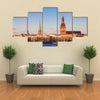 Riga Cathedrals, St. Peters Church Over The Bank Of River Riga, Latvia Multi Panel Canvas Wall Art