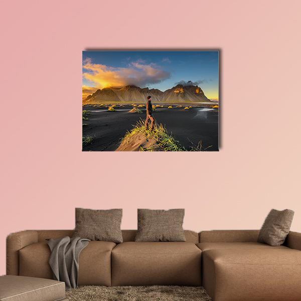 Hiker enjoying sunset at Vestrahorn and its black sand wall art