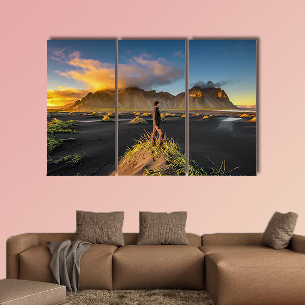 Hiker enjoying sunset at Vestrahorn and its black sand wall art