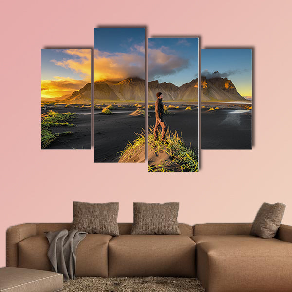 Hiker enjoying sunset at Vestrahorn and its black sand wall art