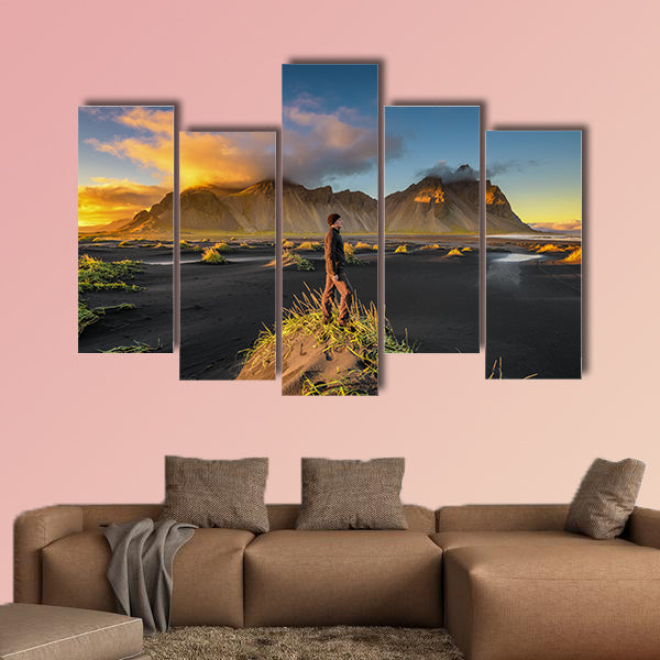 Hiker enjoying sunset at Vestrahorn and its black sand wall art