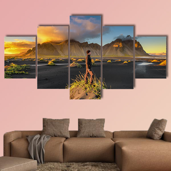 Hiker enjoying sunset at Vestrahorn and its black sand wall art
