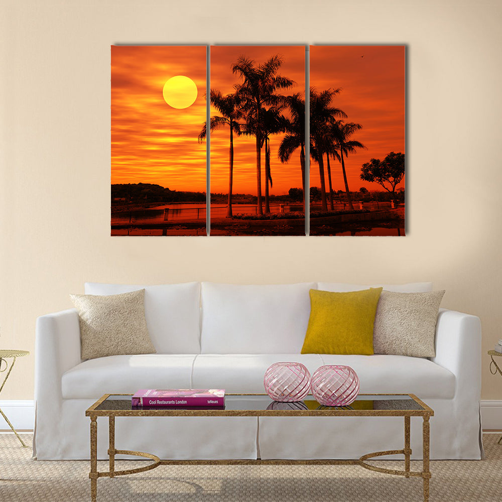 Palm Tree With The Sunset At A Beach Multi Panel Canvas Wall Art