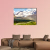 High mountains with ice field next to road with buses wall art