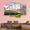 High mountains with ice field next to road with buses wall art