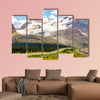 High mountains with ice field next to road with buses wall art