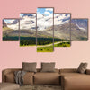 High mountains with ice field next to road with buses wall art