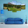 Grassy meadow at the foot of the mountain, beautiful landscape with spruce forest on hillside multi panel canvas wall art