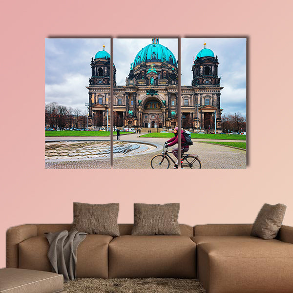 Man riding a bicycle at Berliner Dom Cathedral in Berlin on Mitte Island, wall art
