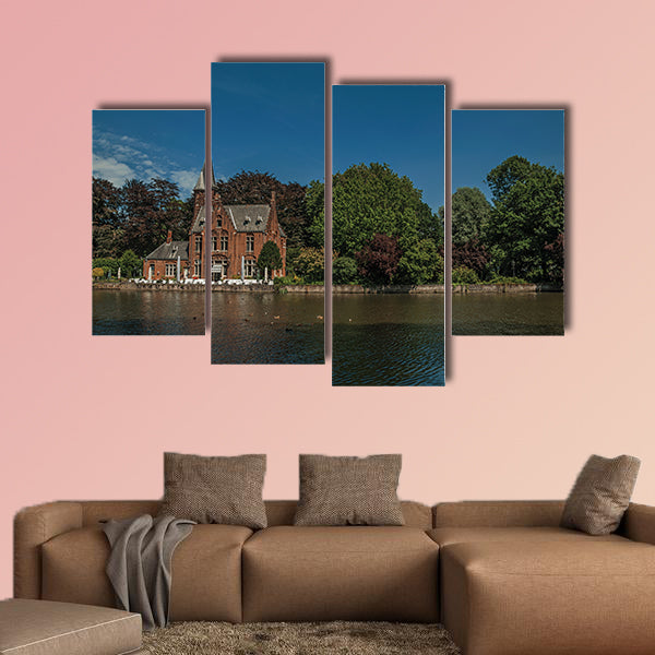Amazing lake surrounded by greenery and old brick building multi panel canvas wall art