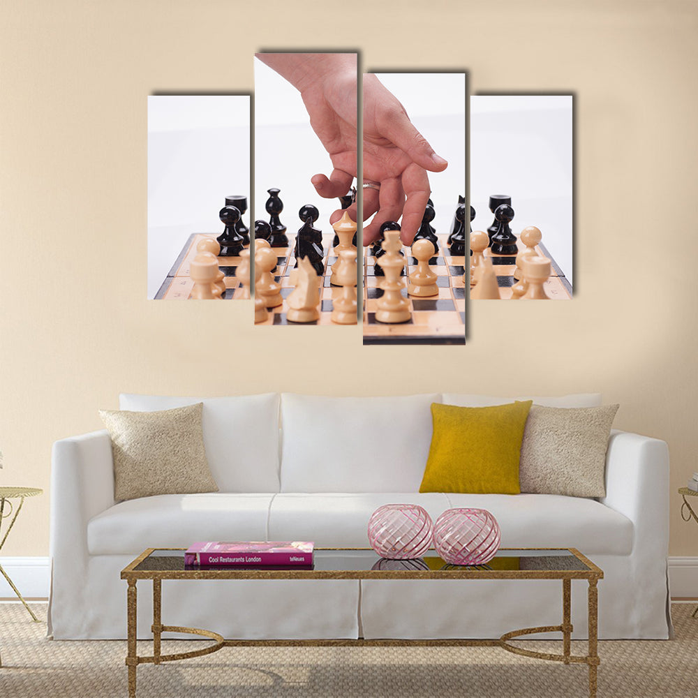 Panning shot of a chess board with a hand moving the chess pieces multi panel canvas wall art