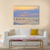 People enjoying themselves and swimming in the sea during sunset multi panel canvas wall art