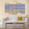 People enjoying themselves and swimming in the sea during sunset multi panel canvas wall art