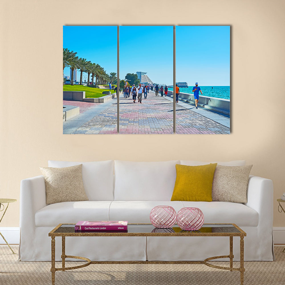 The crowded promenade in West Bay neighborhood with modern building of Sheraton grand Resort on background Multi panel canvas wall art