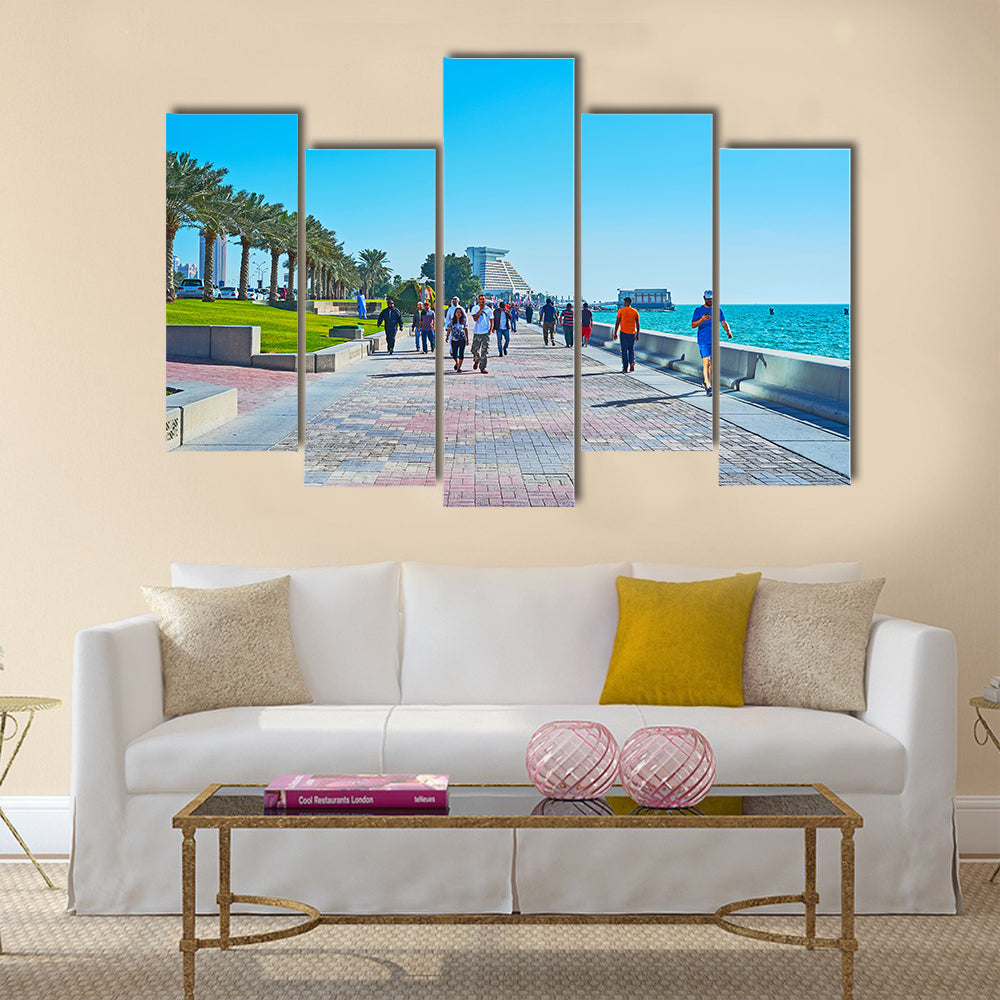 The crowded promenade in West Bay neighborhood with modern building of Sheraton grand Resort on background Multi panel canvas wall art