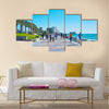 The crowded promenade in West Bay neighborhood with modern building of Sheraton grand Resort on background Multi panel canvas wall art