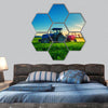 farming tractor plowing and spraying on field hexagonal canvas wall art