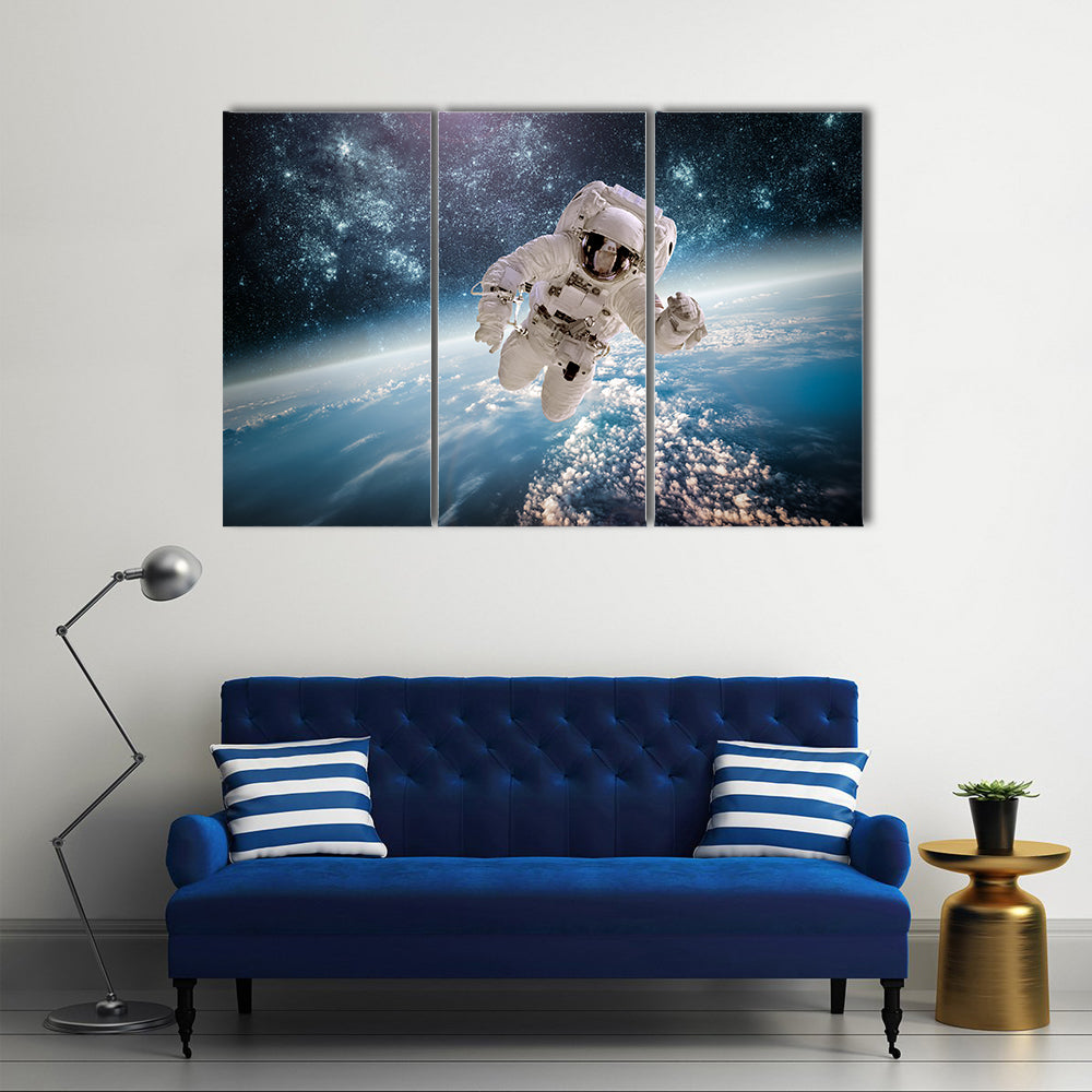 Astronaut In Outer Space Near The Back Drop Of Earth Multi Panel Canvas Wall Art