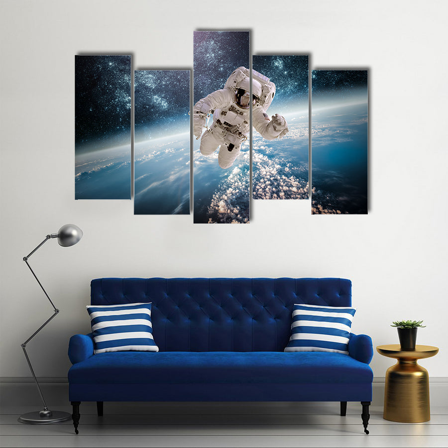 Astronaut In Outer Space Near The Back Drop Of Earth Multi Panel Canvas Wall Art