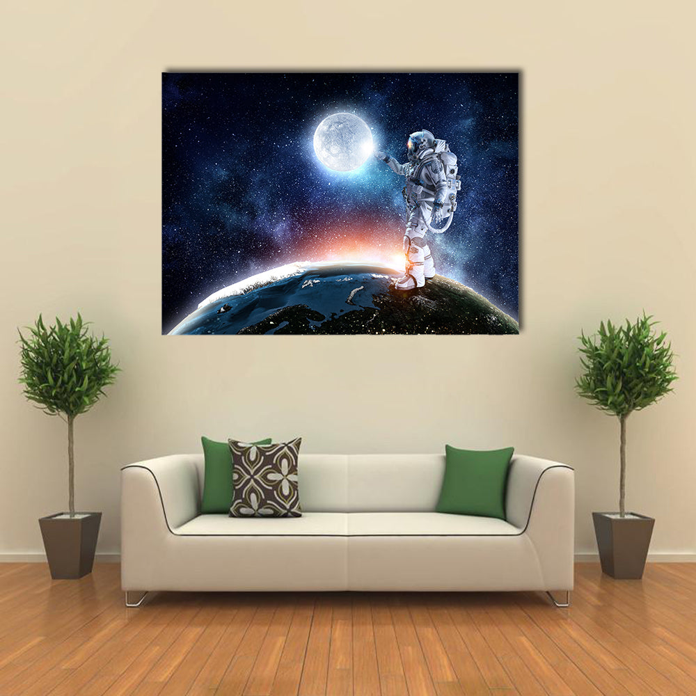 Astronaut Pointing The Moon For A Candid Click Multi Panel Canvas Wall Art