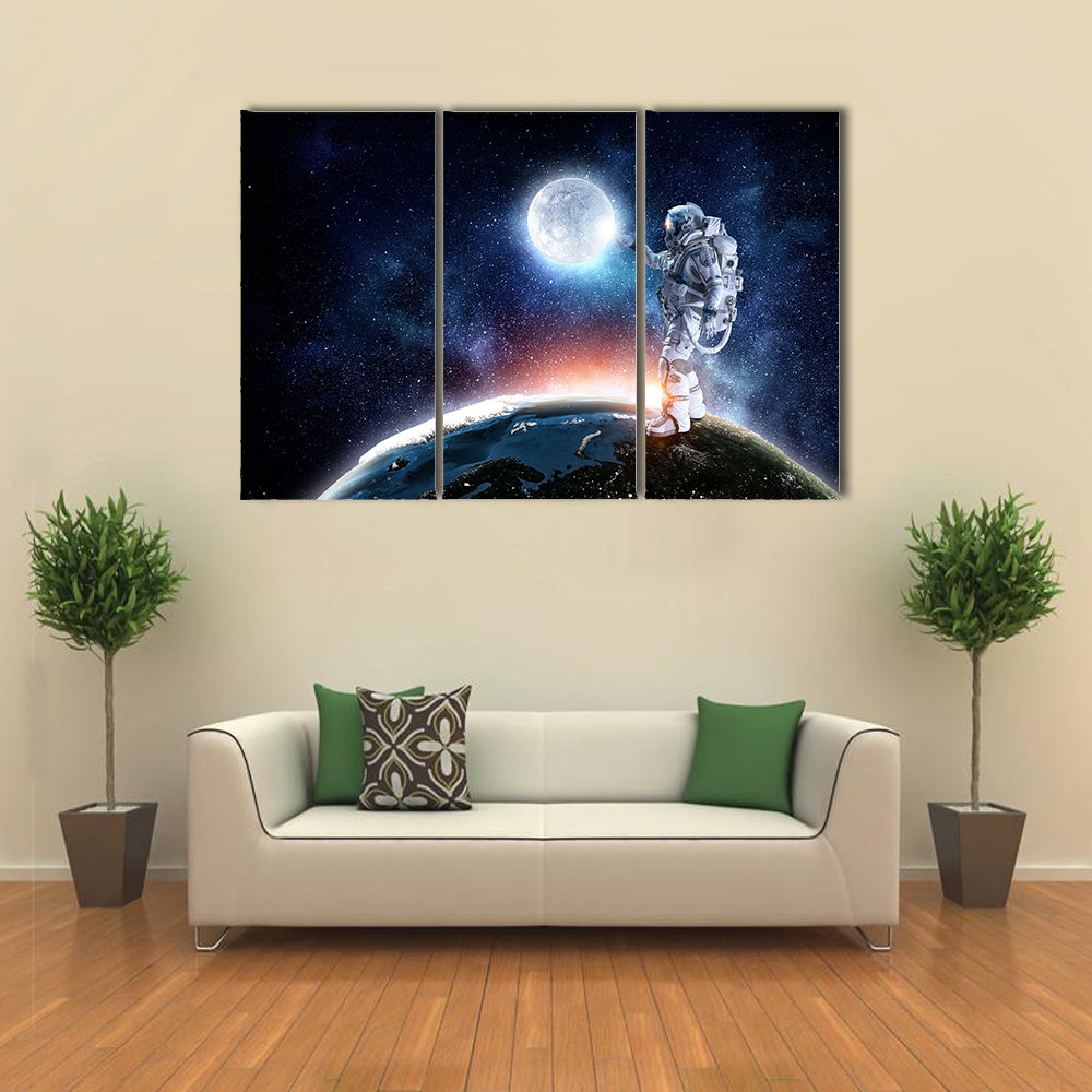 Astronaut Pointing The Moon For A Candid Click Multi Panel Canvas Wall Art